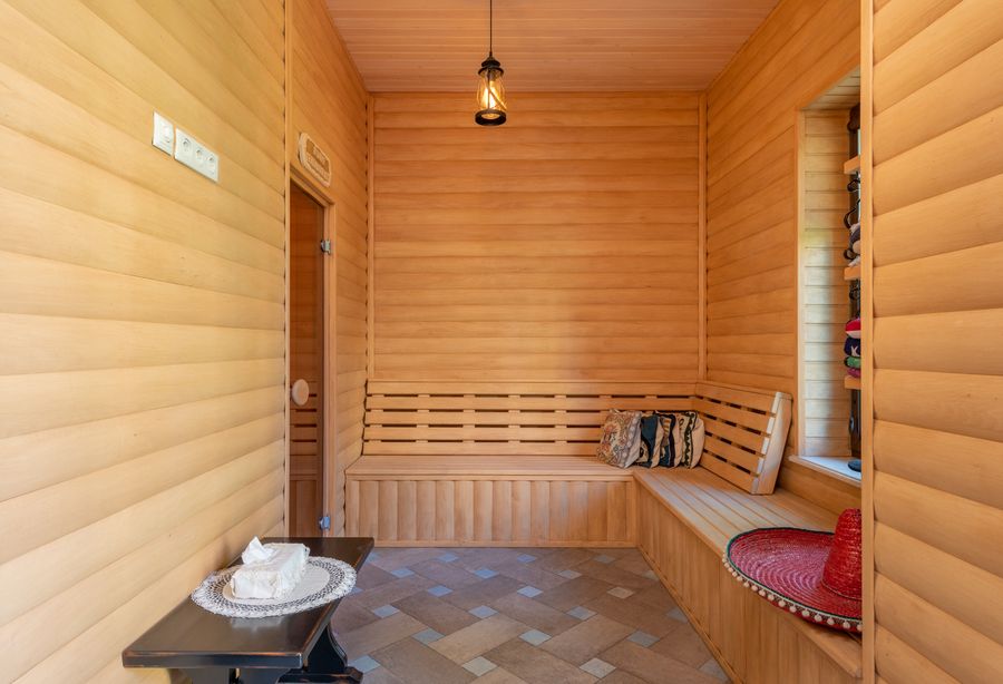 Birch venik bundle resting on a bench in the Mahipalpur banya room