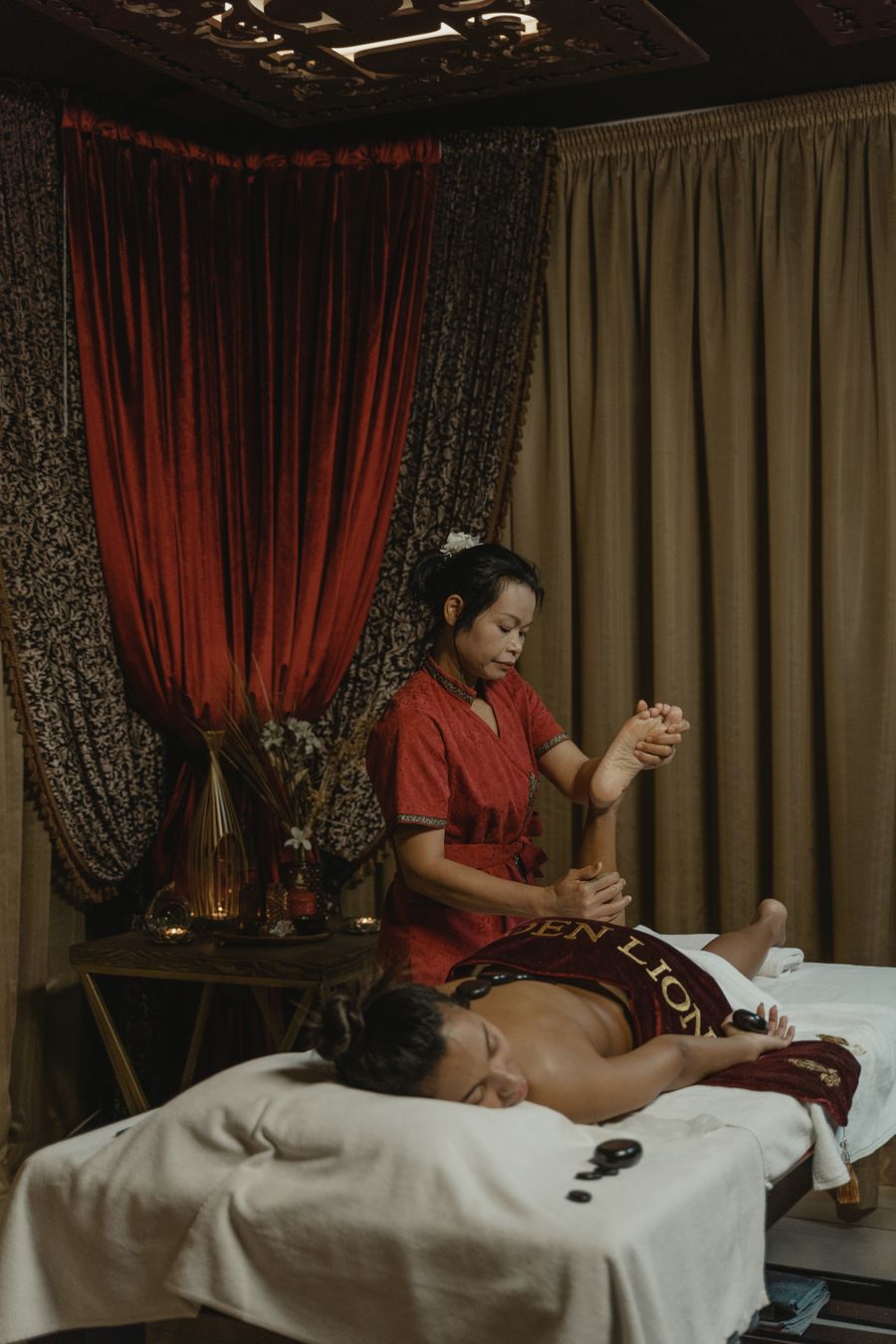 Warm herbal oil being poured for an Ayurvedic Abhyanga treatment